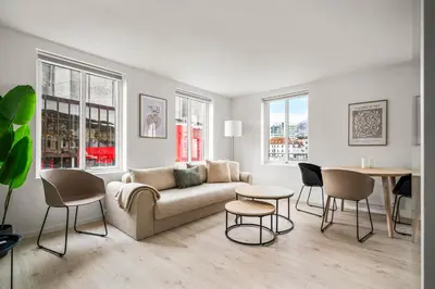 a living room with a couch and chairs and a table at City Center, Light & Modern Apartment in Bergen