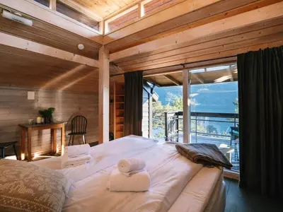 a large bed in a room with a large window at 2 person holiday home in Balestrand in Balestrand