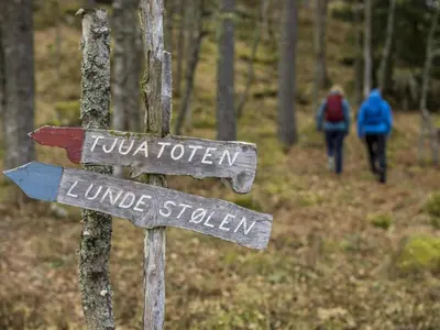 a sign for a hiking trail in the woods at 2 person holiday home in Balestrand in Balestrand