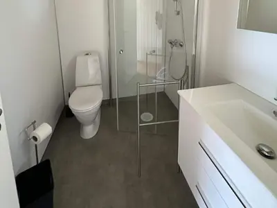 a bathroom with a toilet and a glass shower at 2 person holiday home in Balestrand in Balestrand