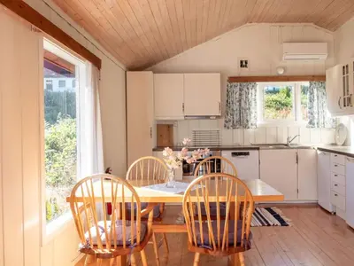 a kitchen with a wooden table and chairs and a table and chairsktop at 2 person holiday home in Balestrand in Balestrand