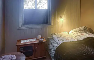 a bedroom with a bed and a table with acomputer on it at Cozy Home In Sparbu With Wifi in Sparbu