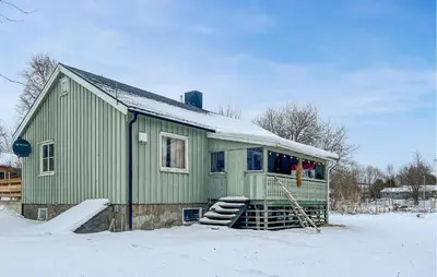 a green house in the snow with snow at Cozy Home In Sparbu With Wifi in Sparbu