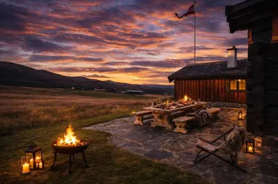 a fire pit in front of a log cabin with a table and fires at Historical & exclusive cabin - Ski in-out - 18 people in Nord-Fron