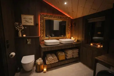 a bathroom with two sinks and a mirror and towels at Historical & exclusive cabin - Ski in-out - 18 people in Nord-Fron