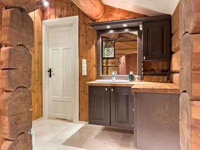 a bathroom with a sink and a mirror at Exclusive cottage Jacuzzi View Ski in out in Aurdal