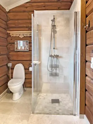 a bathroom with a toilet and a shower at Exclusive cottage Jacuzzi View Ski in out in Aurdal
