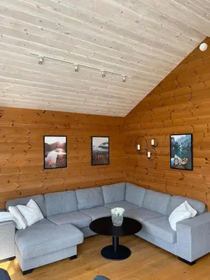 a living room with a couch and a table at Velkommen til topp leilighet på Strandafjellet 2 soverom og hems in Stranda