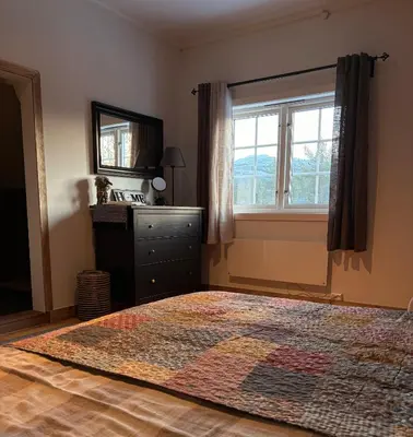 a bedroom with a rug on the floor and a window at Valhalla Hytte in Oppdal