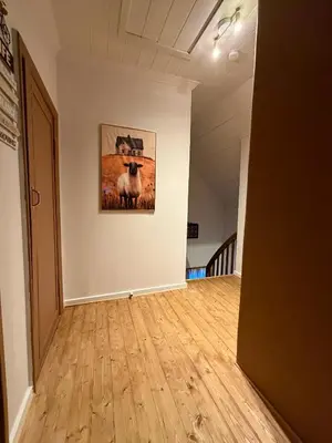 a hallway with a painting of a sheep on a wall at Valhalla Hytte in Oppdal