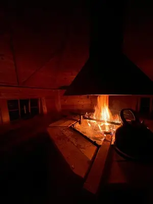 a fireplace in a room with fire in it at Valhalla Hytte in Oppdal