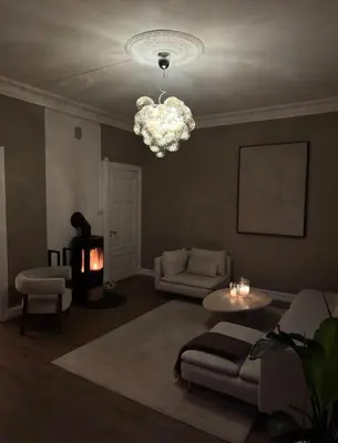 a living room with a couch and a chandelier at Central Jugend apartment in Ålesund in Ålesund