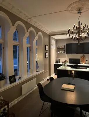 a dining room and kitchen with a table and chairs at Central Jugend apartment in Ålesund in Ålesund