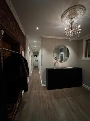 a hallway with a mirror and a chandelier in a room at Central Jugend apartment in Ålesund in Ålesund