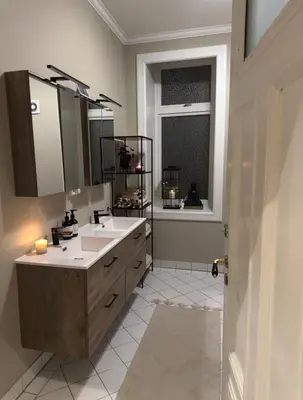 a bathroom with a sink and a mirror and a window at Central Jugend apartment in Ålesund in Ålesund