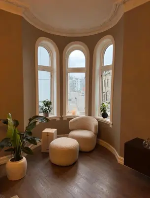 a living room with two chairs and two windows at Central Jugend apartment in Ålesund in Ålesund