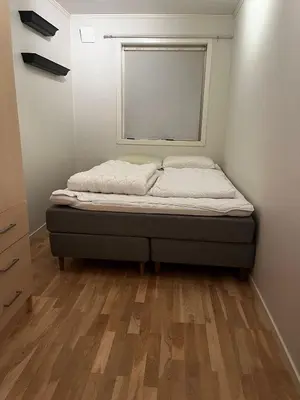 a small bed in a room with a window at Apartment Stedjeåsen 70 in Sogndal