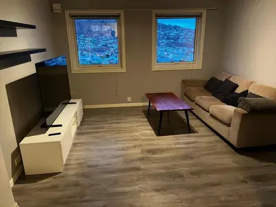a living room with a couch and a table at Apartment Stedjeåsen 70 in Sogndal