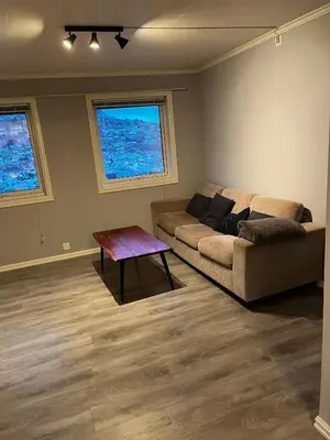 a living room with a couch and a table at Apartment Stedjeåsen 70 in Sogndal
