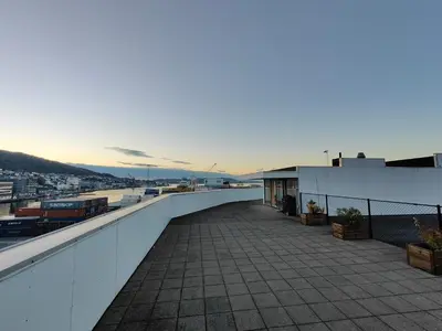 a balcony of a building with a view of a harbor at Modern apartment in central Bergen in Bergen
