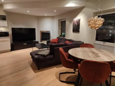 a living room with a couch and a table at Modern apartment in central Bergen in Bergen