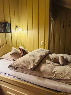 a bed with pillows on it in a room at Luxury cabin in the mountains, with sauna and steam shower in Geilo