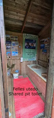 a small bathroom with a tub and a pink rug at Smia cabin , A Unique Rustic Hideaway in Lii