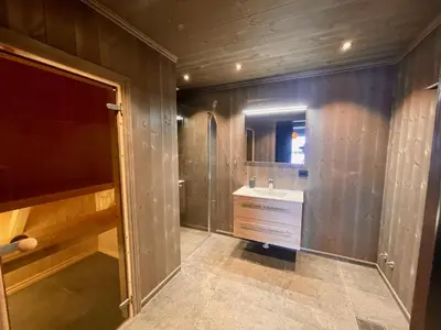 a bathroom with a sink and a mirror at Luxurious Cabin, 5 Bedrooms, Sauna Stunning View in Beitostøl