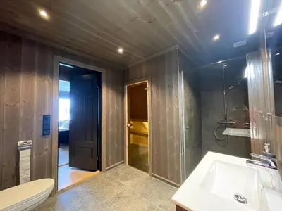 a bathroom with a shower and a toilet and a sink at Luxurious Cabin, 5 Bedrooms, Sauna Stunning View in Beitostøl