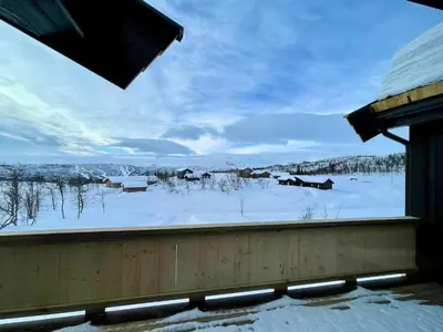 a view of a snow covered field from a window at Luxurious Cabin, 5 Bedrooms, Sauna Stunning View in Beitostøl