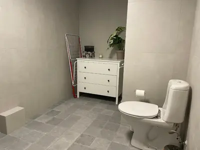 a bathroom with a white toilet and a dresser at Peis, Utsikt Og 200 M Til Bakken in Beitostøl