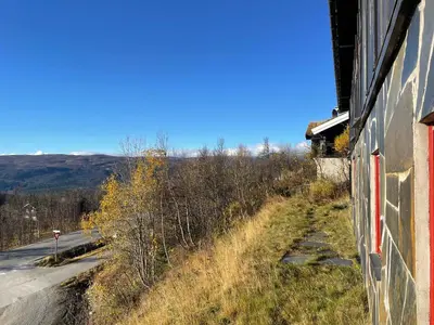 a view of the side of a building next to a road at Peis, Utsikt Og 200 M Til Bakken in Beitostøl