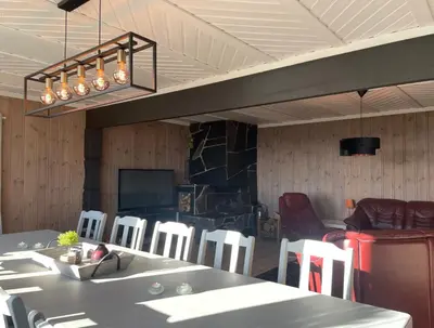 a dining room with a table and white chairs at Peis, Utsikt Og 200 M Til Bakken in Beitostøl