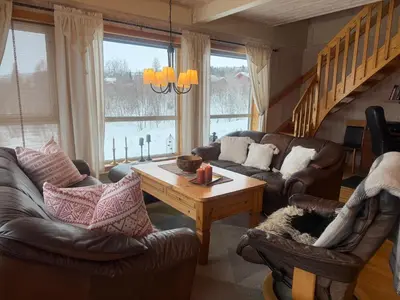 a living room with couches and a coffee table at Koselig Leilighet Med Flott Utsikt in Beitostøl