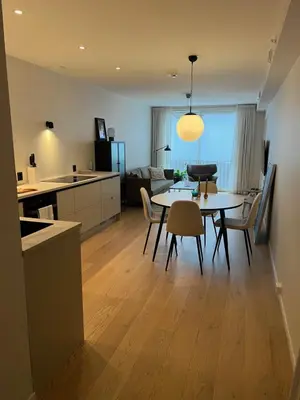 a kitchen and dining room with a table and chairs at Leilighet 101 og 102 i Brunholmgata 9 in Ålesund