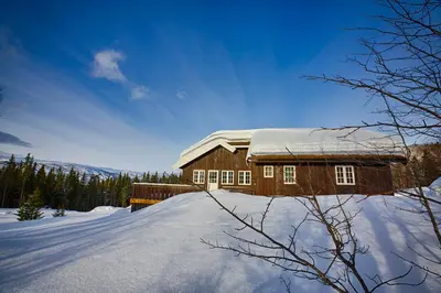 a house with a snow covered roof in the snow at Relax And Unwind At Slettero-A Cozy Family Getaway in Beitostøl