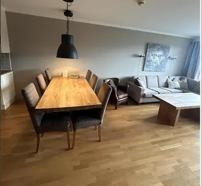 a living room with a wooden table and chairs at Familievennlig Leilighet Med 7 Sengeplasser in Beitostøl