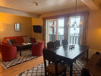 a living room with a table and a couch at 3-Roms Leilighet Nær Alle Beitostølens Fasiliteter in Beitostøl