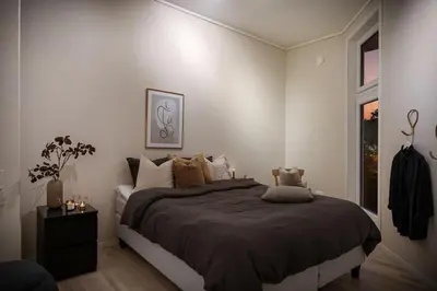 a bedroom with a bed and a window at Nice apartment near the city center! in Bergen