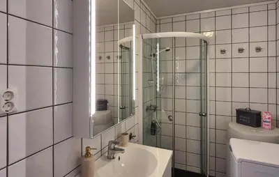 a bathroom with a sink and a shower with a mirror at 2 Bedroom Cozy Apartment In Røldal in Røldal