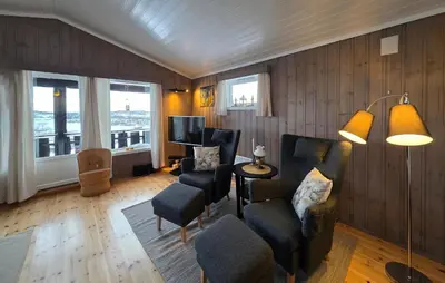a living room with chairs and a tv and windows at Nice Home In Rauland With Wifi in Rauland