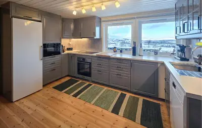 a kitchen with stainless steel appliances and a large window at Nice Home In Rauland With Wifi in Rauland