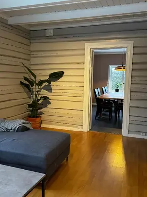 a room with a bed and a table and a dining room at Huset i den lykkelige gaten in Elverum