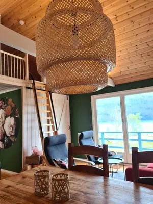 a large chandelier in a room with chairs and a table at Nordfjordcabins BLUE in Utvik