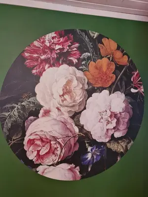 a painting of pink flowers on a green wall at Nordfjordcabins BLUE in Utvik