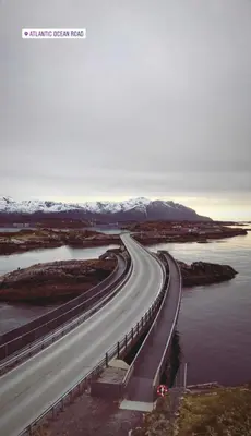a highway with a bridge over a body of water at Leilighet i paradisbukta in Torvikbukt