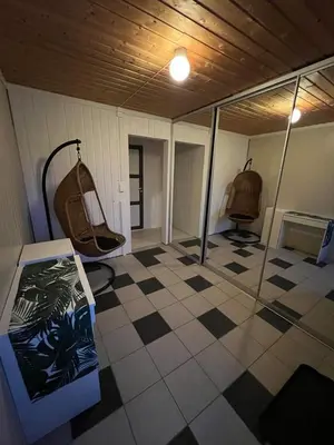 a room with a checkered floor and a room with a mirror at Leilighet i paradisbukta in Torvikbukt