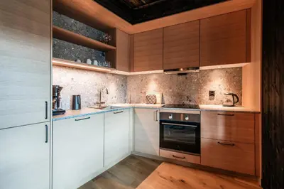 a kitchen with white cabinets and wooden counters at Kikut Alpin Lodge 2102 in Hol