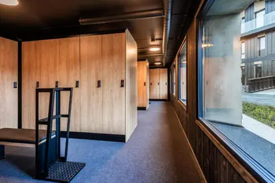 a hallway with wooden walls and a window at Kikut Alpin Lodge 2102 in Hol