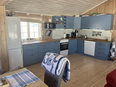 a kitchen with blue cabinets and a stove top oven at Mountain cabin in Lillehammer in Lillehammer